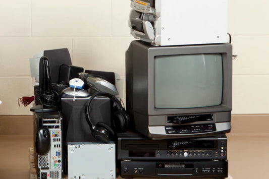 Various e-waste. Including a small tv with built in VCR, headphones, a VCR, a audio receiver, a computer case, mouse, and modem, plus some other items.