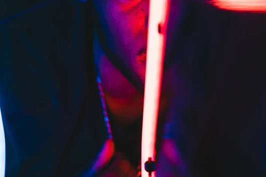 A closeup of a neon lighting tube that is turned on. The tube is reddish pink in color.