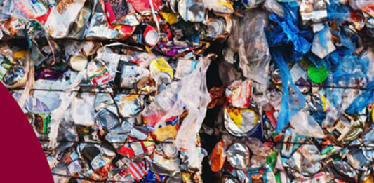 A close up of recycled blue box materials compressed into two bails. 